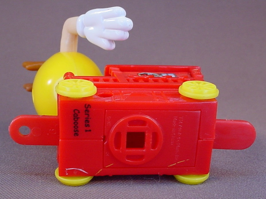 M&M Yellow Figure Riding A Red Train Caboose, 2005 Christmas Train, The Arms Move, 3 1/4 Inches Tall, M & M Candy, M And M