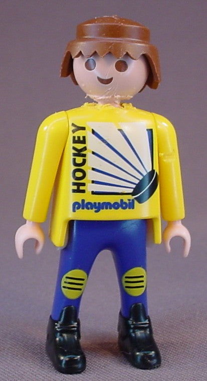 Playmobil Adult Male Hockey Player Figure In Blue Pants And A Yellow Jersey With Hockey Puck Design