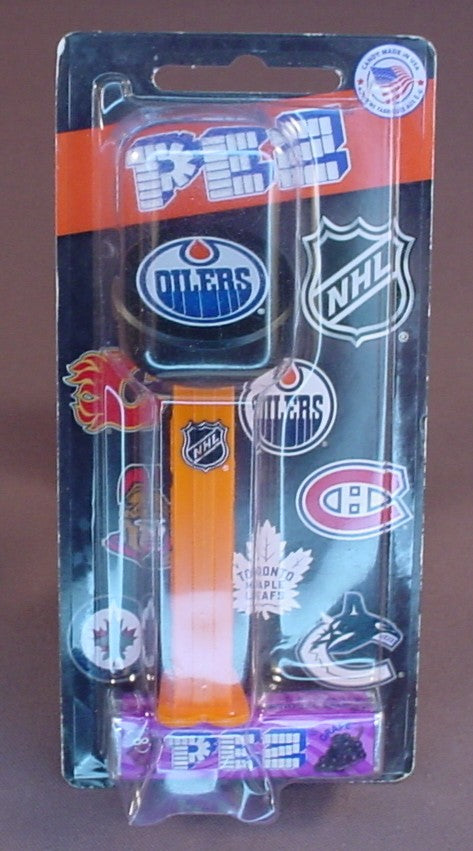 Pez NHL Hockey Edmonton Oilers Logo On A Black Puck, In The Original Packaging, Orange Stem With The NHL Logo, Pez Candy Dispenser