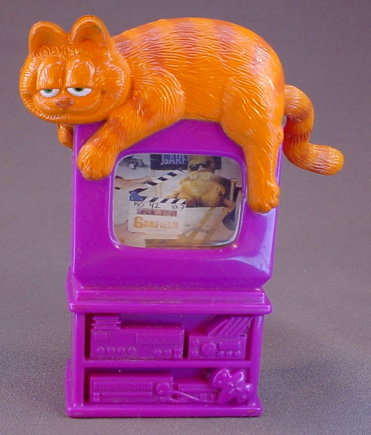 Garfield The Cat Movie Toy With Garfield Laying On Top Of A TV Set, Turn His Tail To Change The Scenes, 4 1/2 Inches Tall, 2004 Wendy's
