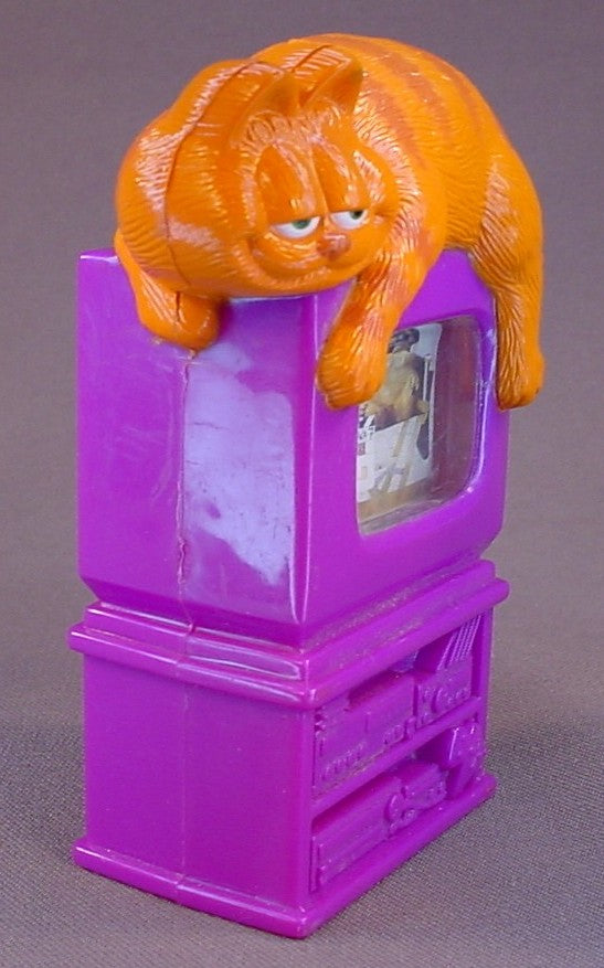 Garfield The Cat Movie Toy With Garfield Laying On Top Of A TV Set, Turn His Tail To Change The Scenes, 4 1/2 Inches Tall, 2004 Wendy's