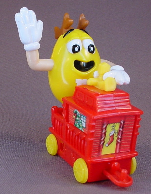 M&M Yellow Figure Riding A Red Train Caboose, 2005 Christmas Train, The Arms Move, 3 1/4 Inches Tall, M & M Candy, M And M