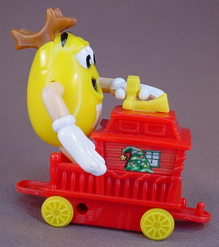 M&M Yellow Figure Riding A Red Train Caboose, 2005 Christmas Train, The Arms Move, 3 1/4 Inches Tall, M & M Candy, M And M