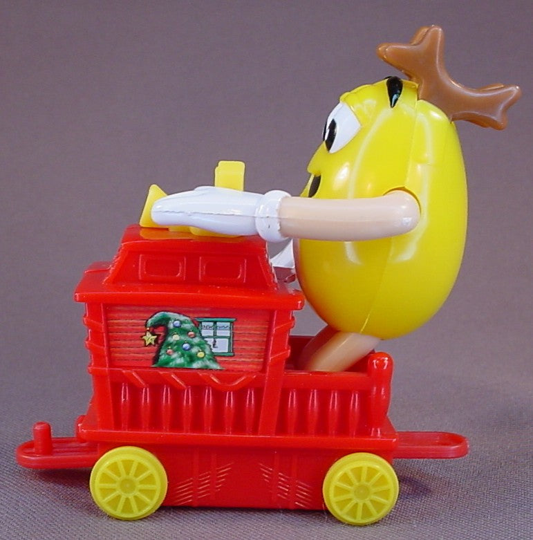 M&M Yellow Figure Riding A Red Train Caboose, 2005 Christmas Train, The Arms Move, 3 1/4 Inches Tall, M & M Candy, M And M