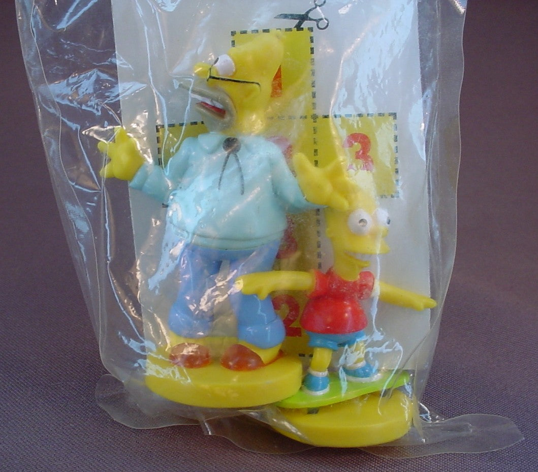 The Simpsons Grampa And Bart Figures In The Sealed Bag, 2003 Kellogg's Cereal Premiums, Simpson Family, Grampa Is 3 1/8 Inches Tall, PVC Figures On A Base, Kelloggs, Kellogg