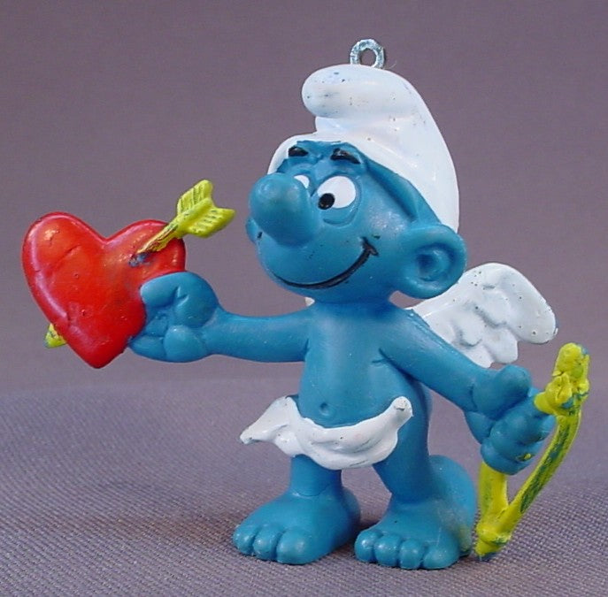 Amour Or Cupid Smurf With A Thin Yellow Bow & A Red Heart PVC Figure, #20128, 1981 Peyo Schleich, W. Germany, Has An Ornament Loop In The Top Of The Head, Smurfs, Vintage, Figurine