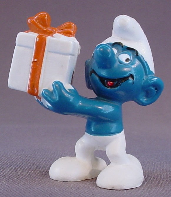 Gift Smurf Carrying A White Present With An Orange Bow PVC Figure, #20086, 1975 Peyo Bully, Made In Hong Kong, Smurfs, Vintage, Figurine