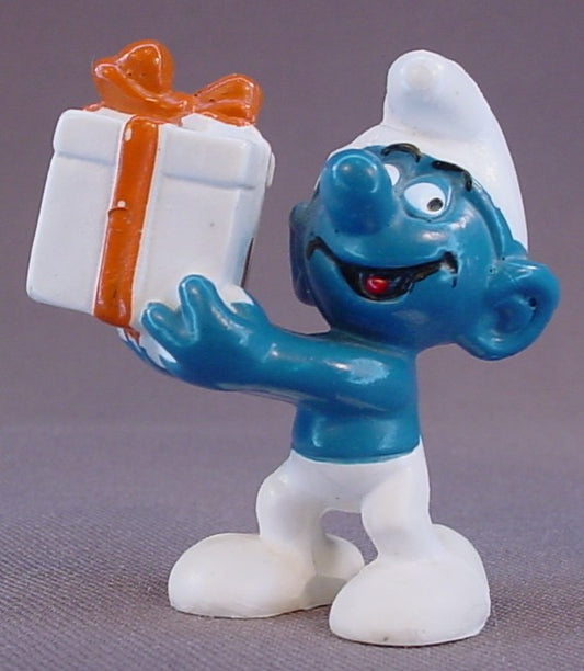 Gift Smurf Carrying A White Present With An Orange Bow PVC Figure, #20086, 1975 Peyo Bully, Made In Hong Kong, Smurfs, Vintage, Figurine
