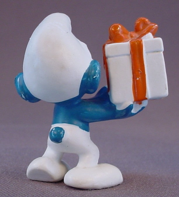 Gift Smurf Carrying A White Present With An Orange Bow PVC Figure, #20086, 1975 Peyo Bully, Made In Hong Kong, Smurfs, Vintage, Figurine