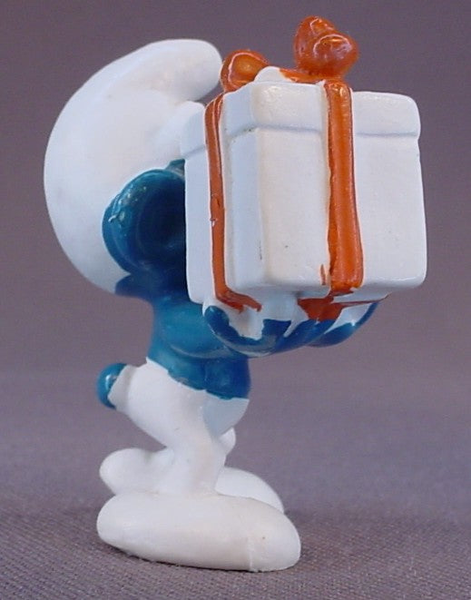 Gift Smurf Carrying A White Present With An Orange Bow PVC Figure, #20086, 1975 Peyo Bully, Made In Hong Kong, Smurfs, Vintage, Figurine