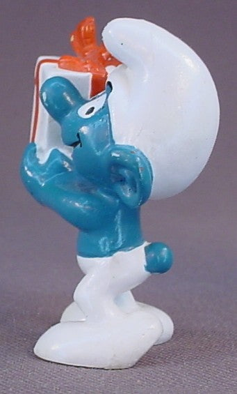 Gift Smurf Carrying A White Present With An Orange Bow PVC Figure, #20086, 1975 Peyo Bully, West Germany, Smurfs, Vintage, Figurine