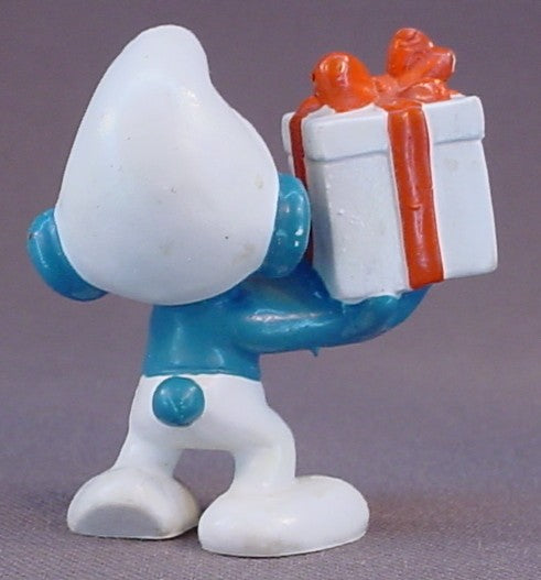 Gift Smurf Carrying A White Present With An Orange Bow PVC Figure, #20086, 1975 Peyo Bully, West Germany, Smurfs, Vintage, Figurine