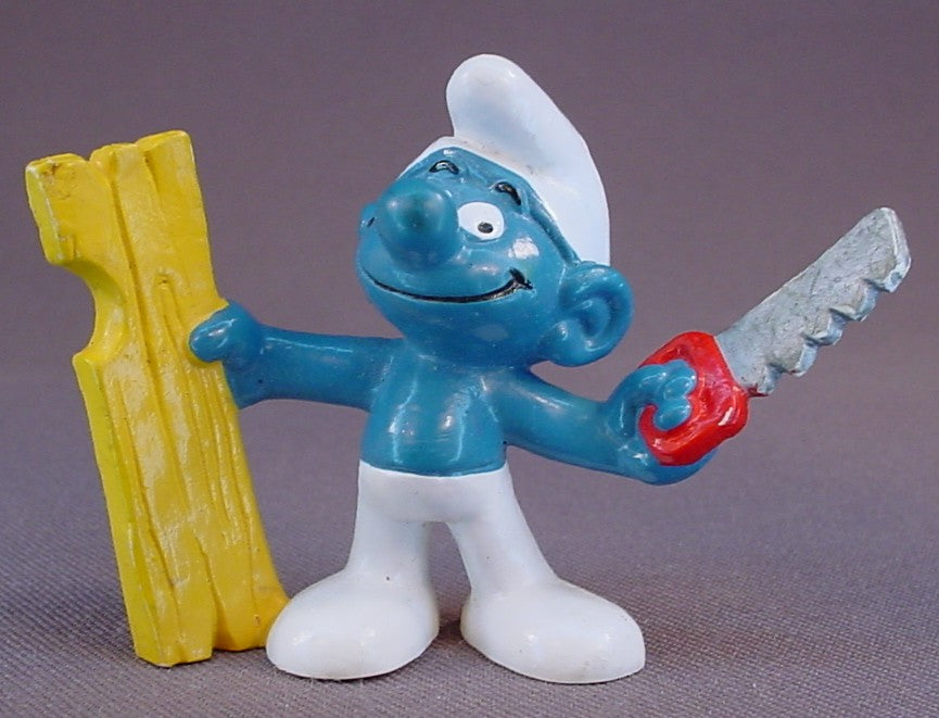 Carpenter Smurf Holding A Saw & A Piece Of Wood PVC Figure, #20112, 1980 Peyo Bully, West Germany, Smurfs, Vintage, Figurine