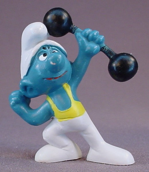 Smurf Wearing White & Yellow Tights & Holding A Black Barbell PVC Figure, #20020, 1972 Peyo, Made In Portugal, Smurfs, Vintage, Figurine, Mustard Yellow Dot