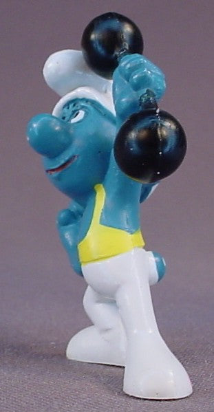 Smurf Wearing White & Yellow Tights & Holding A Black Barbell PVC Figure, #20020, 1972 Peyo, Made In Portugal, Smurfs, Vintage, Figurine, Mustard Yellow Dot
