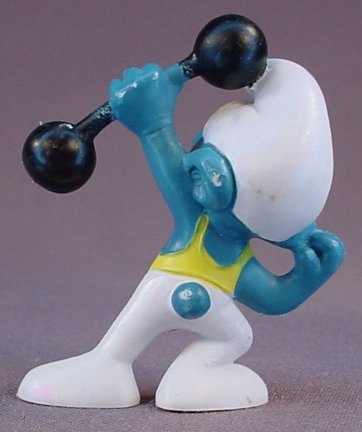 Smurf Wearing White & Yellow Tights & Holding A Black Barbell PVC Figure, #20020, 1972 Peyo, Made In Portugal, Smurfs, Vintage, Figurine, Mustard Yellow Dot