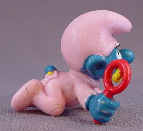 Baby Smurf In A Pink Sleeper & Holding A Rattle PVC Figure, #20202, 1984 Peyo Schleich, Smurfs, Vintage, Figurine, W. Berrie & Co.