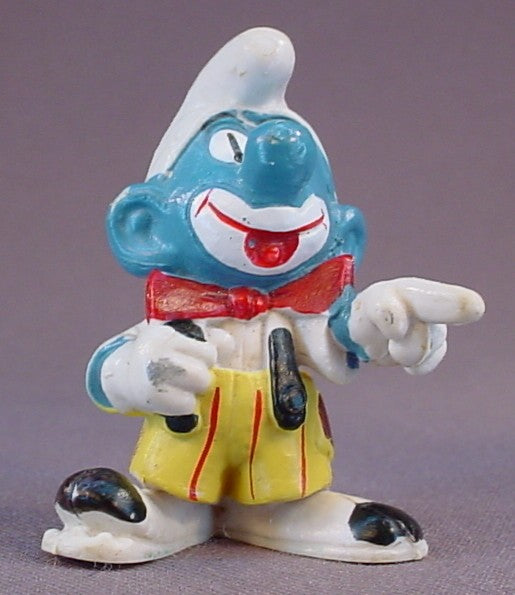 Smurf Clown Pointing His Finger PVC Figure, Yellow Pants With Black Suspenders, #20033, 1978 Peyo Schleich, Smurfs, Vintage, Figurine, Has Cracking In The Paint On His Hat, Mustard Yellow Or Orange Dot