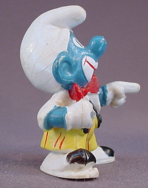 Smurf Clown Pointing His Finger PVC Figure, Yellow Pants With Black Suspenders, #20033, 1978 Peyo Schleich, Smurfs, Vintage, Figurine, Has Cracking In The Paint On His Hat, Mustard Yellow Or Orange Dot
