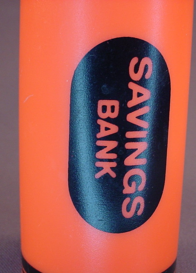 Orange Crayon Shaped Savings Bank With A Removable Bottom, 6 Inches Tall, Has A Coin Slot
