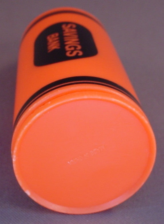 Orange Crayon Shaped Savings Bank With A Removable Bottom, 6 Inches Tall, Has A Coin Slot