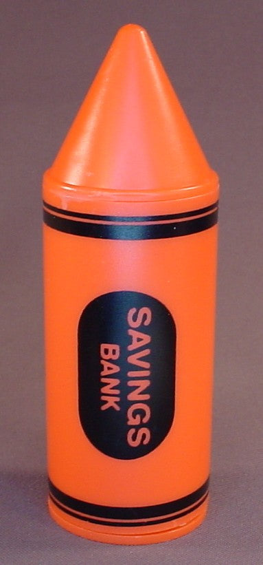 Orange Crayon Shaped Savings Bank With A Removable Bottom, 6 Inches Tall, Has A Coin Slot