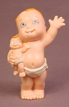 Magic Diaper Babies Baby Holding A Matching Doll Toy, One Arm Raised