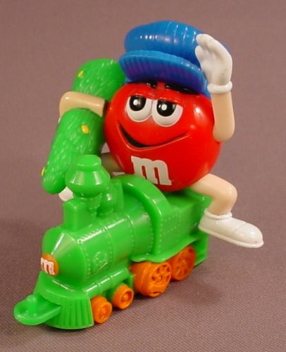 M&M Red Figure Holding A Christmas Tree & Riding On A Train Engine
