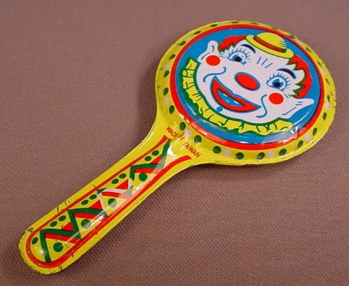 Vintage Metal Noise Maker With A Clown Face On Each Side